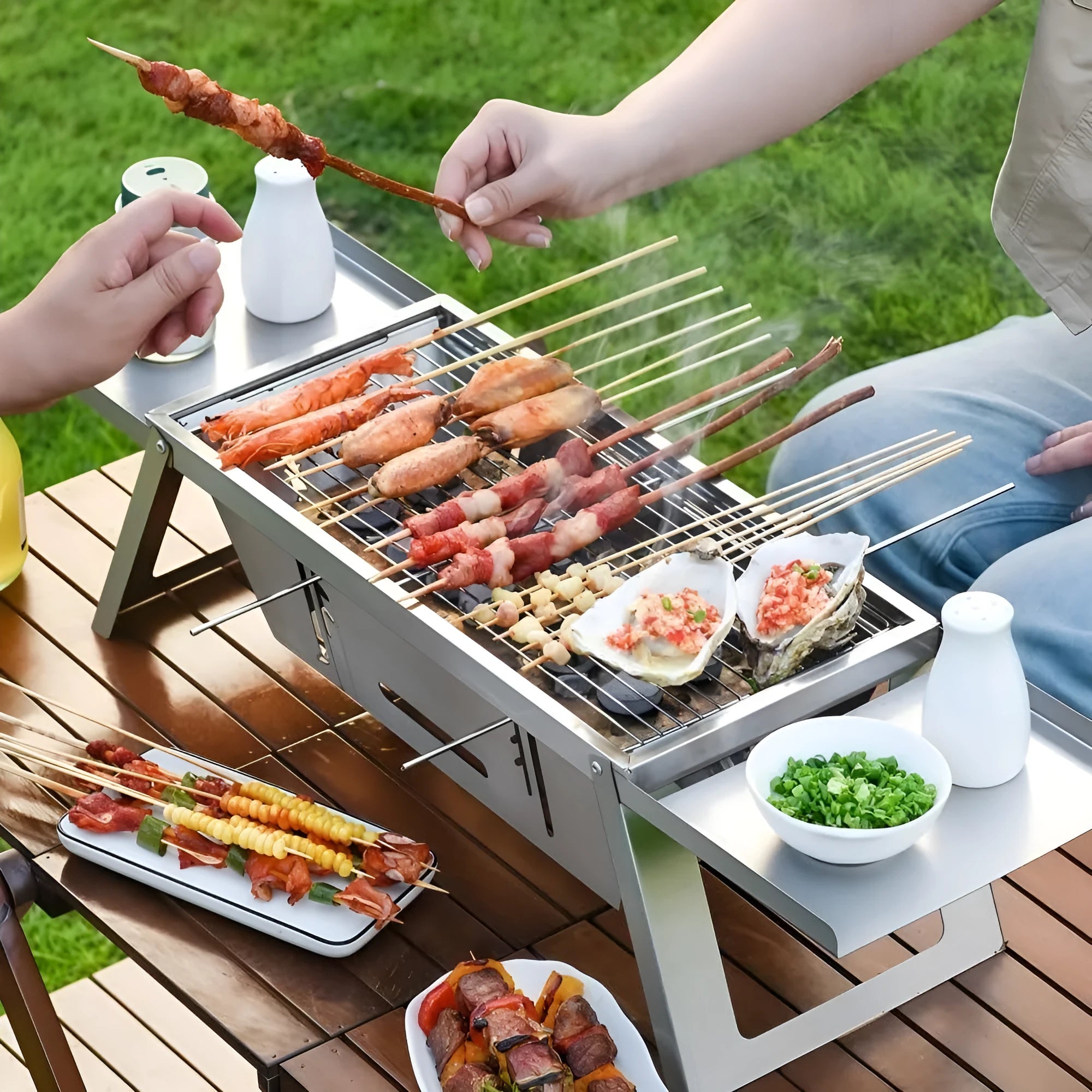 Small portable charcoal grill with folding metal frame for outdoor cooking