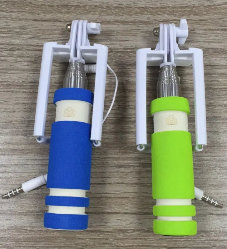 Cell phone folding selfie stick in black plastic, collapsed for storage