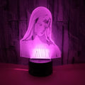 3D LED night light showing colourful dual ring pattern, with remote control and USB cable.