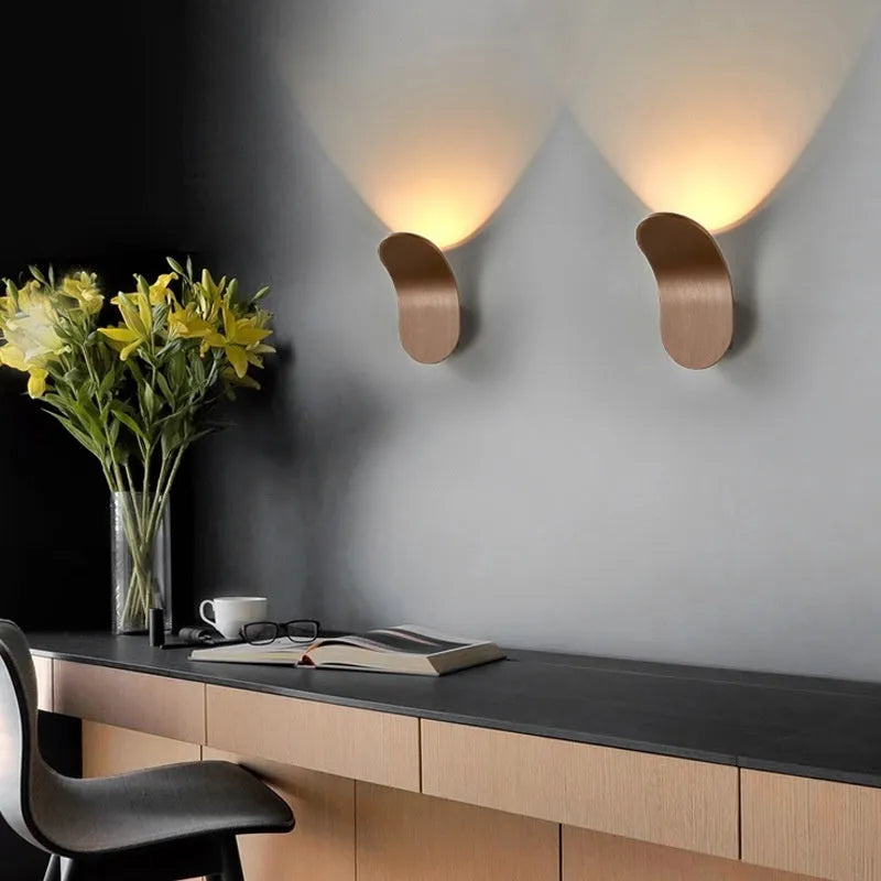 Modern simplicity wall light bulb in brushed black finish against a white wall