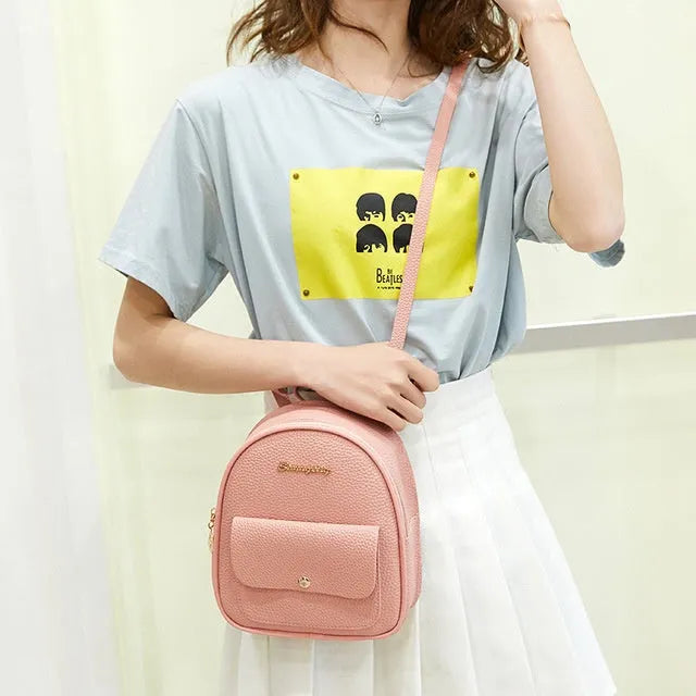 Women's small PU shoulder backpack in solid colour with convertible strap design and zipper closure