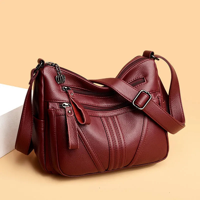 Genuine leather horizontal square messenger bag with contrasting stitching and single shoulder strap in black