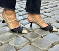 Women's apricot and black colour block pointed toe sandals with a stiletto heel and buckle strap.
