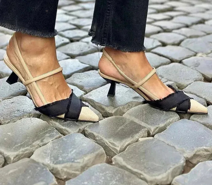 Women's apricot and black colour block pointed toe sandals with a stiletto heel and buckle strap.