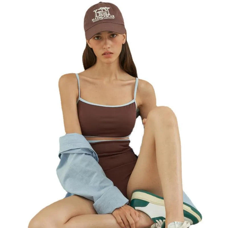 Brown women's one-piece triangle swimsuit on a hanger, showing front design.