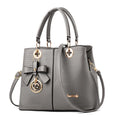 Retro style PU handbag with a zipper and shoulder strap in a choice of colours.