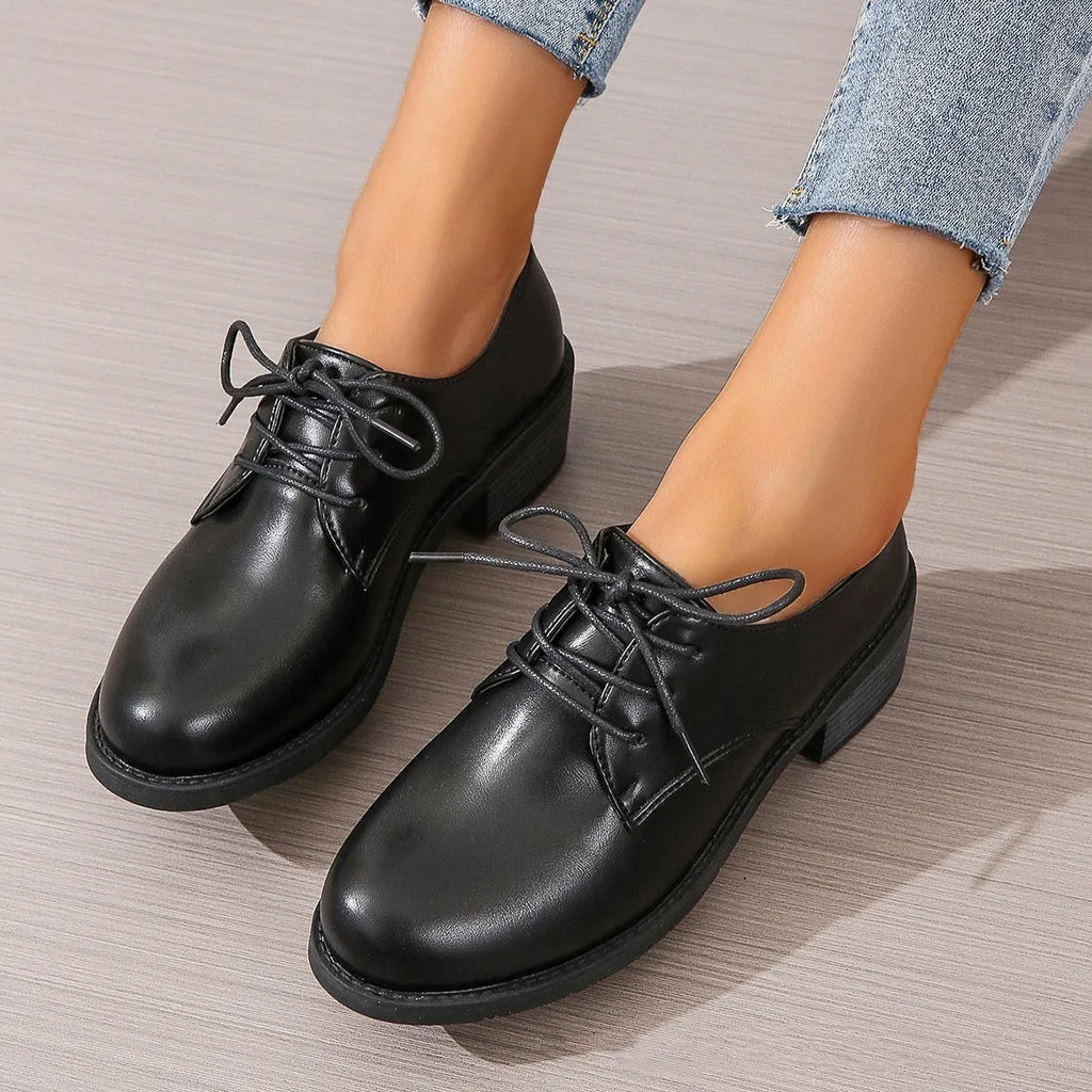 Black women's low-top shoes with a chunky mid-height heel and round toe.