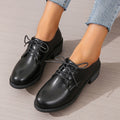 Black women's low-top shoes with a chunky mid-height heel and round toe.