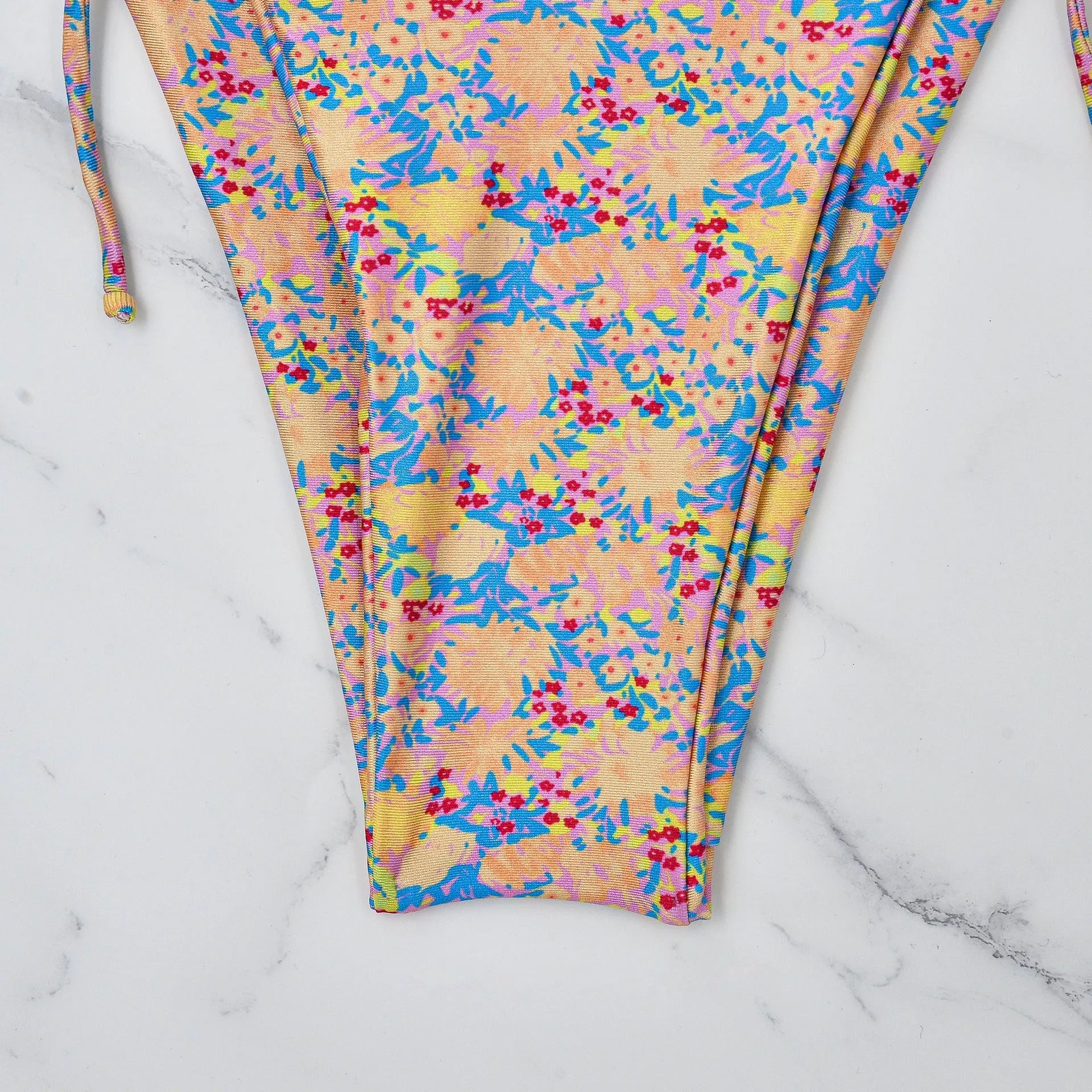 A pictured colour lace-up bikini swimsuit with adjustable ties and a backless briefs design.