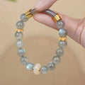 Emerald green Tian Shan Cui half bracelet with floating flower girl design and round motif on light background