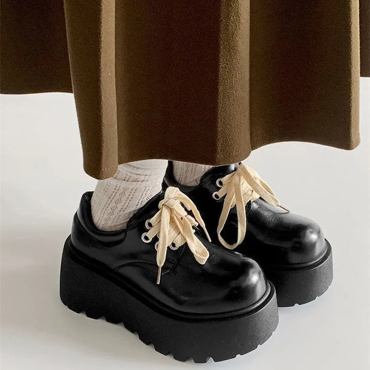 Matte black women's low-top shoes with a chunky 6-8cm heel and thick rubber sole on a white background.