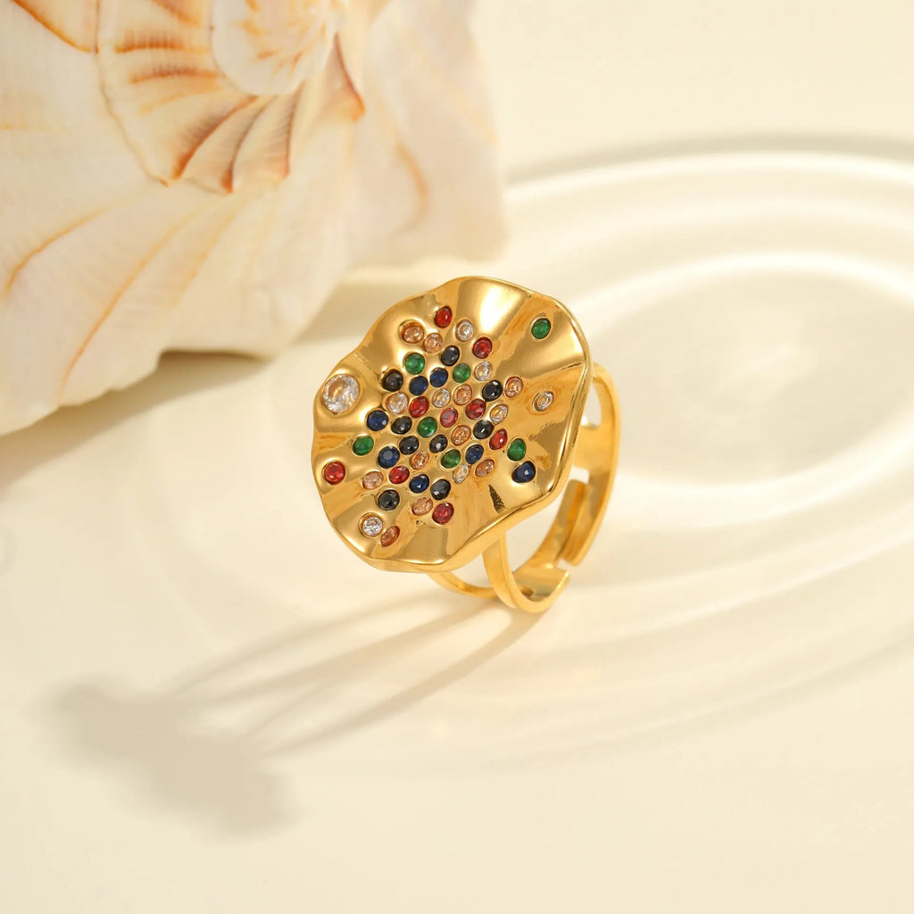Geometric pleated stainless steel ring with colourful inlaid crystals on an adjustable open band.