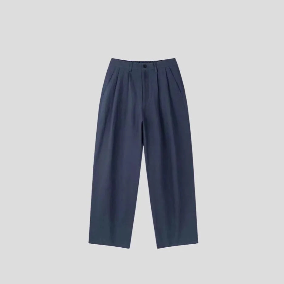 Men's loose fit cotton linen trousers in apricot, army green, and purplish blue, showing pencil leg opening.