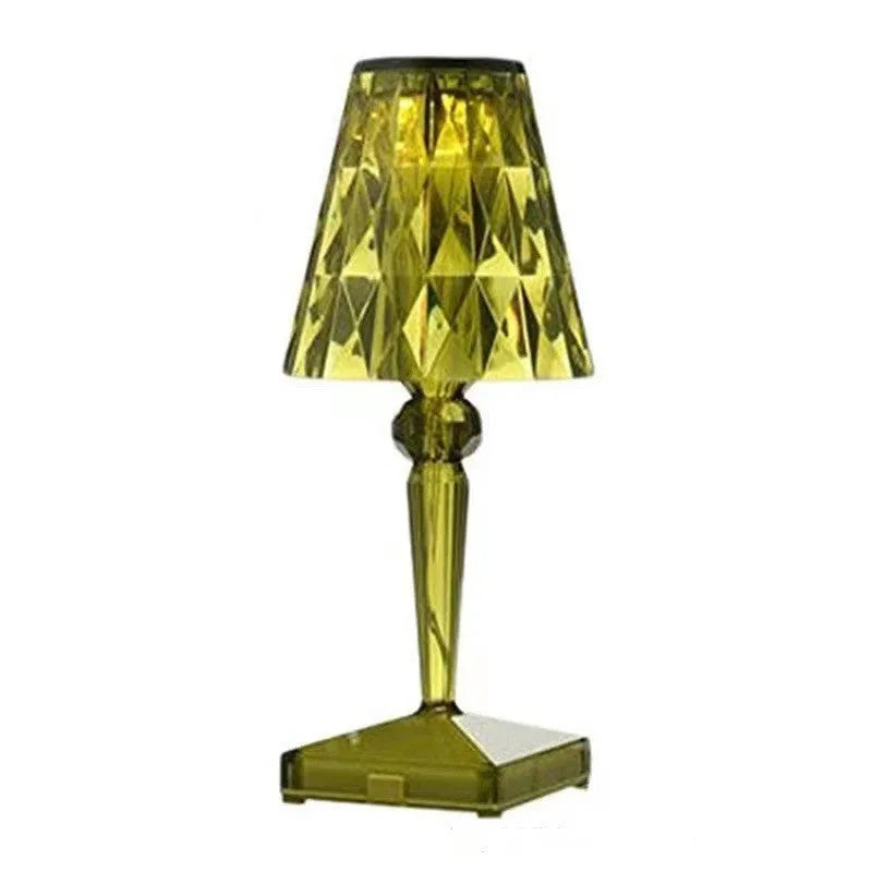 Rose gold plated portable touch control LED night light with acrylic shade on a table.