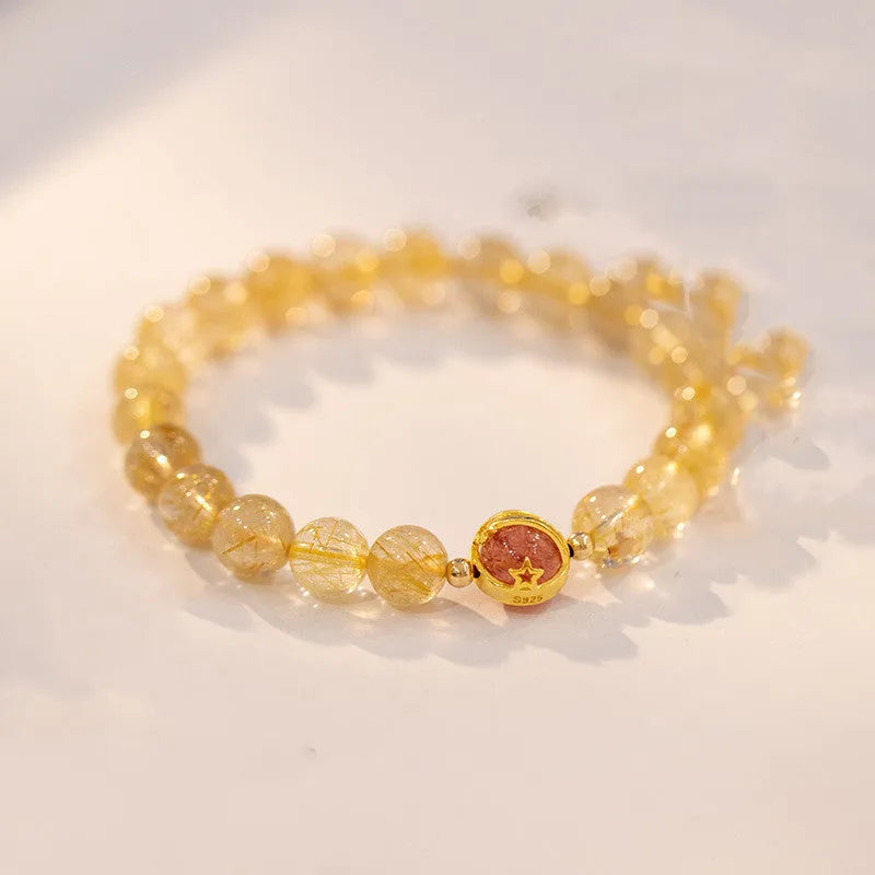 Natural citrine gold rutilated quartz diamond cut bracelet 6mm beads on neutral background