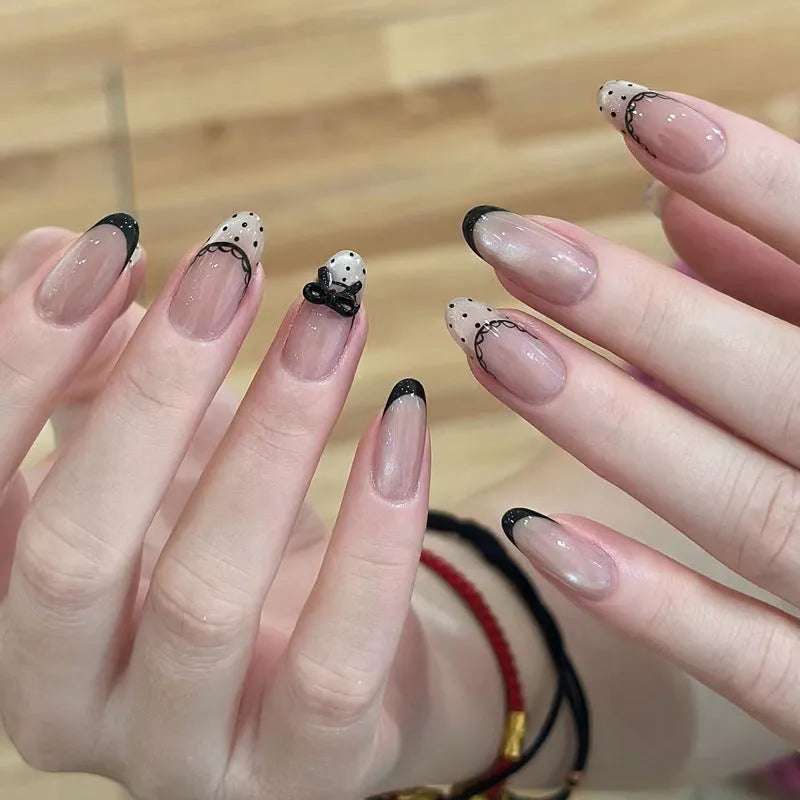 Set of short, colourful fake nails for girls with adhesive tabs on a pink background.