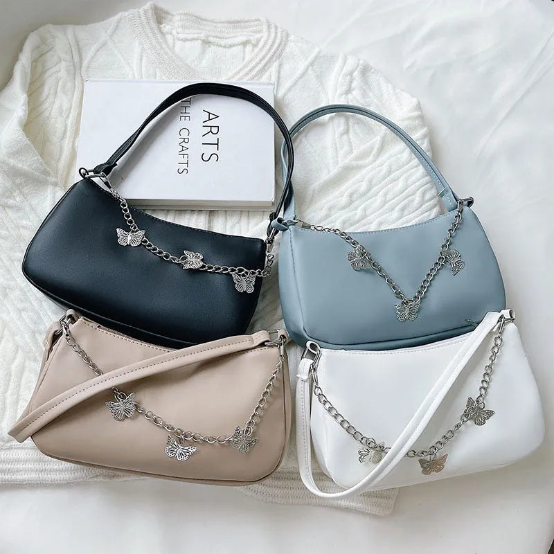 Black PU leather butterfly chain crossbody bag with a square shape and outer pocket.