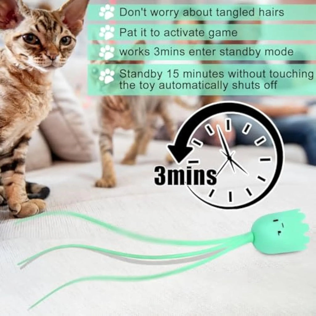 Green automatic electronic cat wand toy with a swinging silicone tail on a wooden floor.
