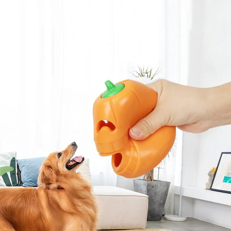 Orange Halloween pumpkin-shaped dog chew toy with a treat-dispensing funnel opening.