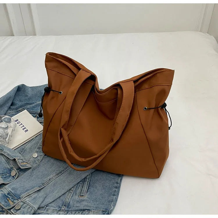 Soft folding Oxford cloth tote bag in a street style, shown in multiple colour options.