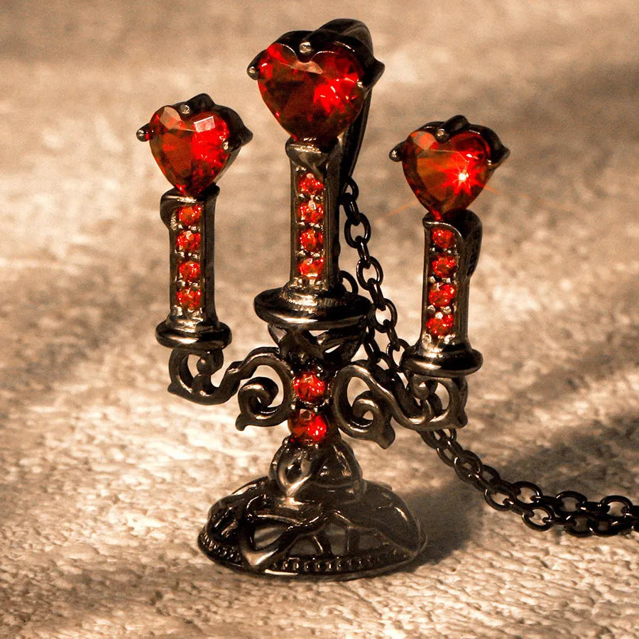 Close-up of a women's Gothic alloy necklace with a hollow candlestick pendant and cross chain links.