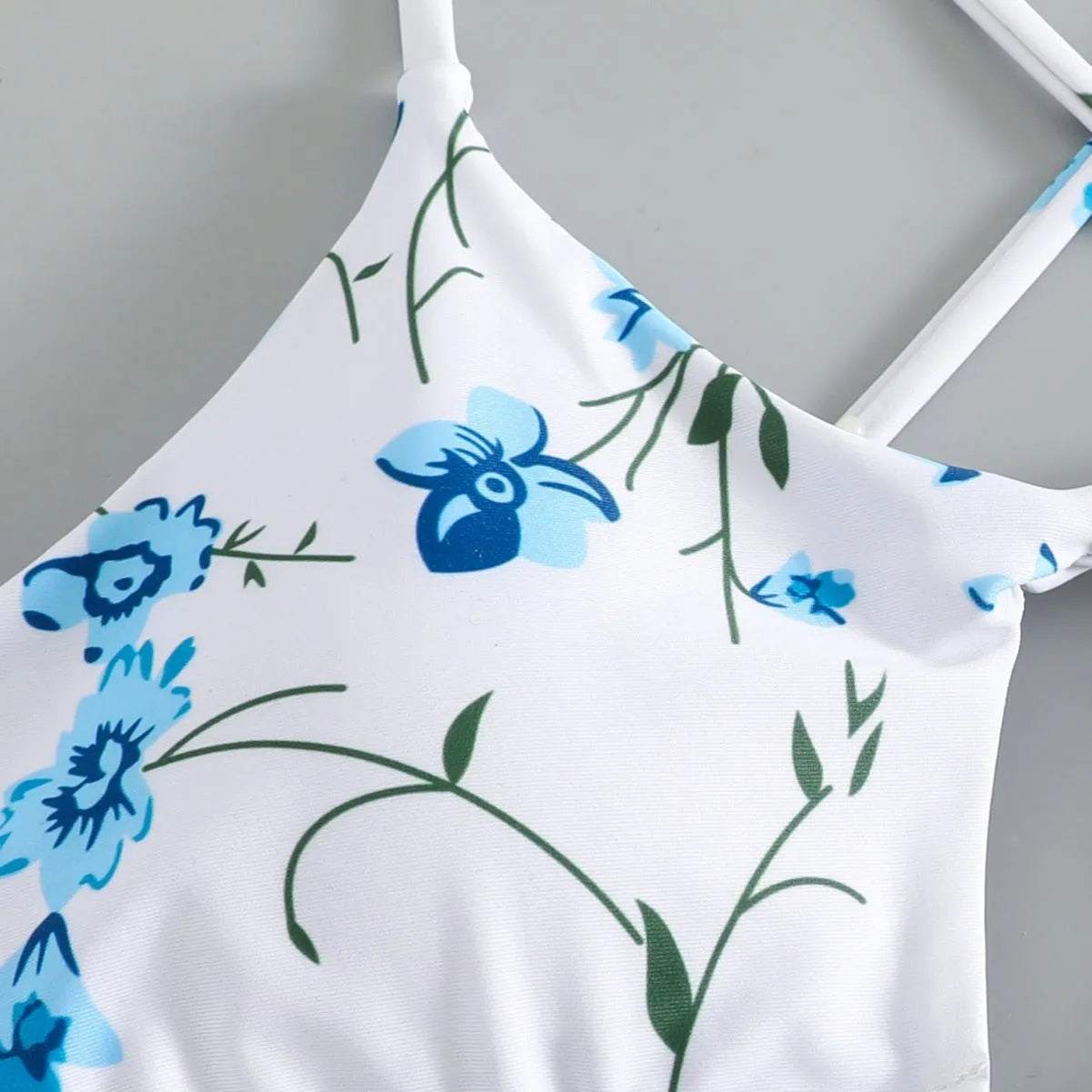 Women's floral tie-neck triangle swimsuit set with polyester lining and matching shorts in multiple colours sizes XS to XL.