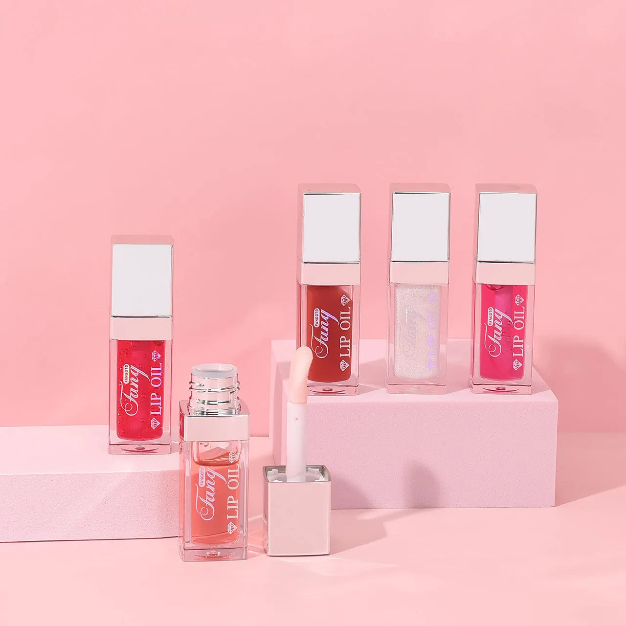 Five tubes of bright mint lip gloss lipstick in different shades on a white background.