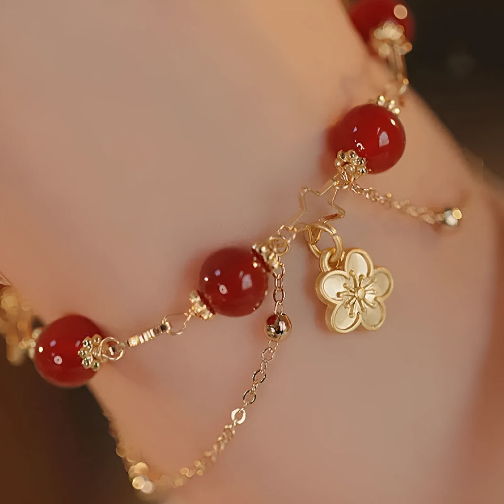 Red agate double layer bracelet with peach blossom decoration on female wrist