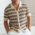 Blue short-sleeve sweater with textured hollow jacquard corrugated pattern and flocking details on a mannequin.