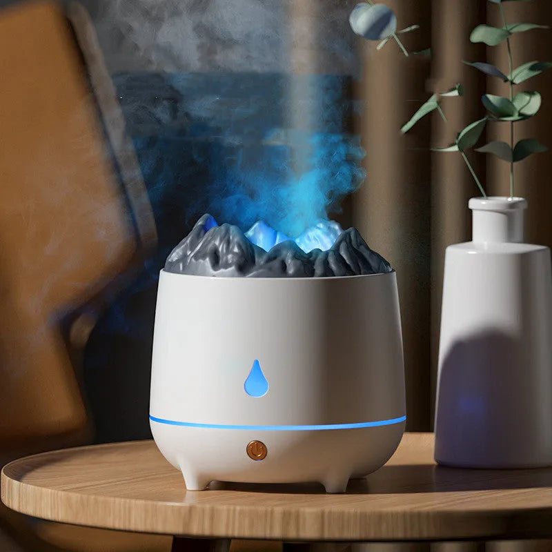 White volcano-shaped ultrasonic humidifier and aromatherapy diffuser with USB cable on a wooden table.