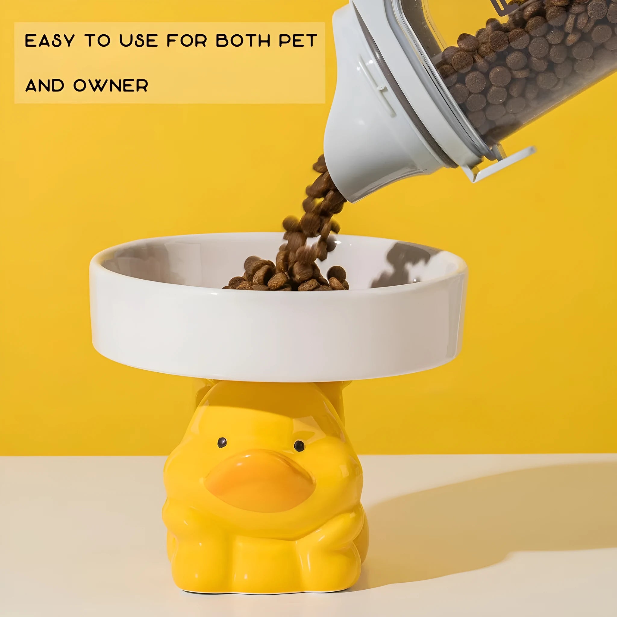 A raised ceramic cat bowl in an animal design, showing its height and wide opening for whisker-friendly feeding.