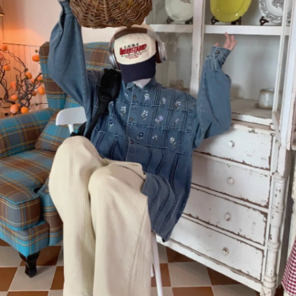 Washed blue long sleeved denim shirt with small floral pattern and pleated details on front