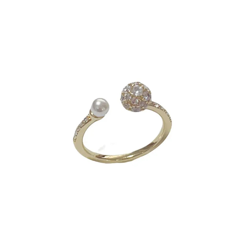 Women's open-end pearl ring with round zircon on geometric copper design in gold plating