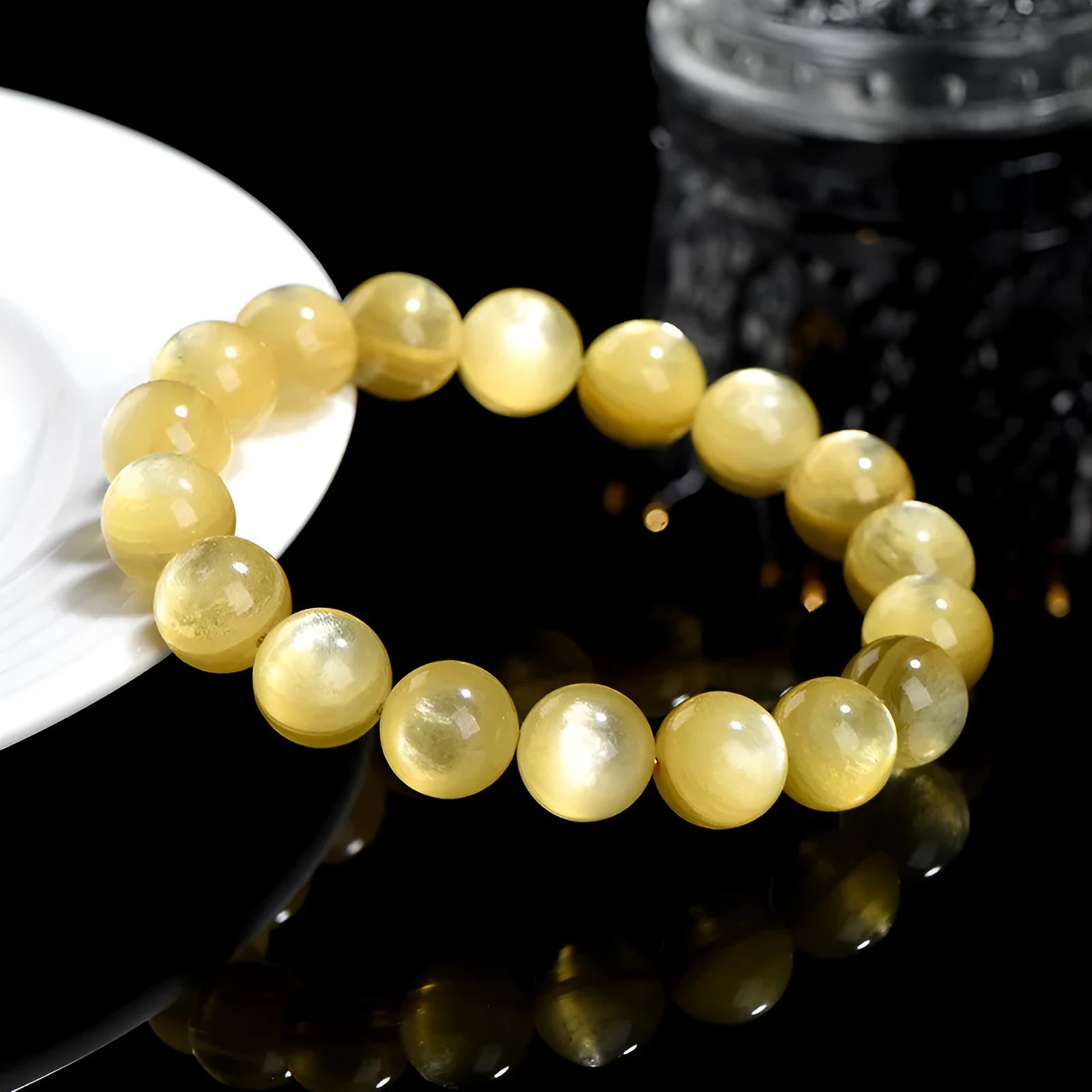 Polished natural mica round beads bracelet in yellow Lepidolite colour on flat surface