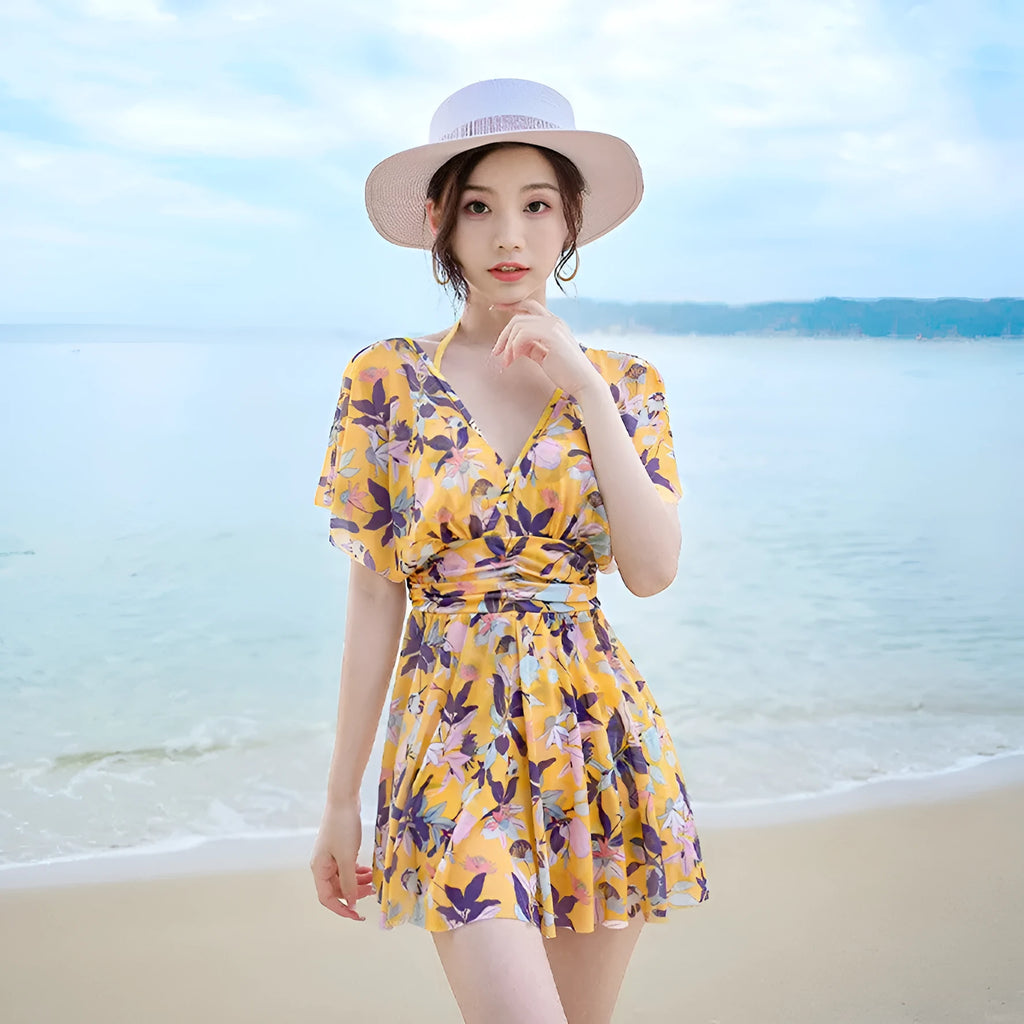 Women's yellow floral one-piece swimsuit with attached skirt, made from polyester, available in multiple sizes