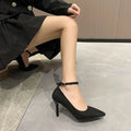 Women's black stiletto heel pump shoes with skull pattern and buckle detail on a white background