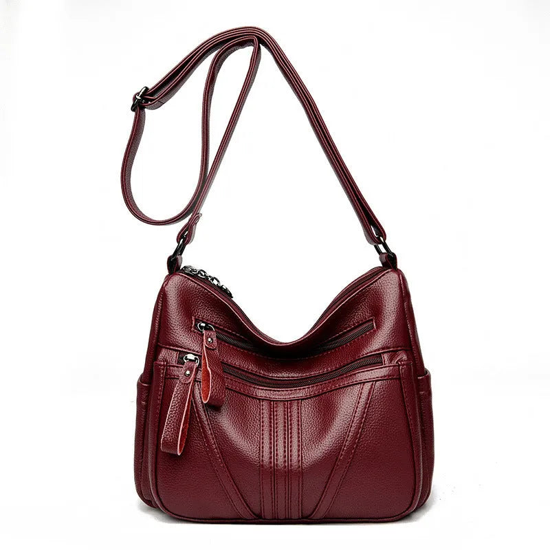 Genuine leather horizontal square messenger bag with contrasting stitching and single shoulder strap in black