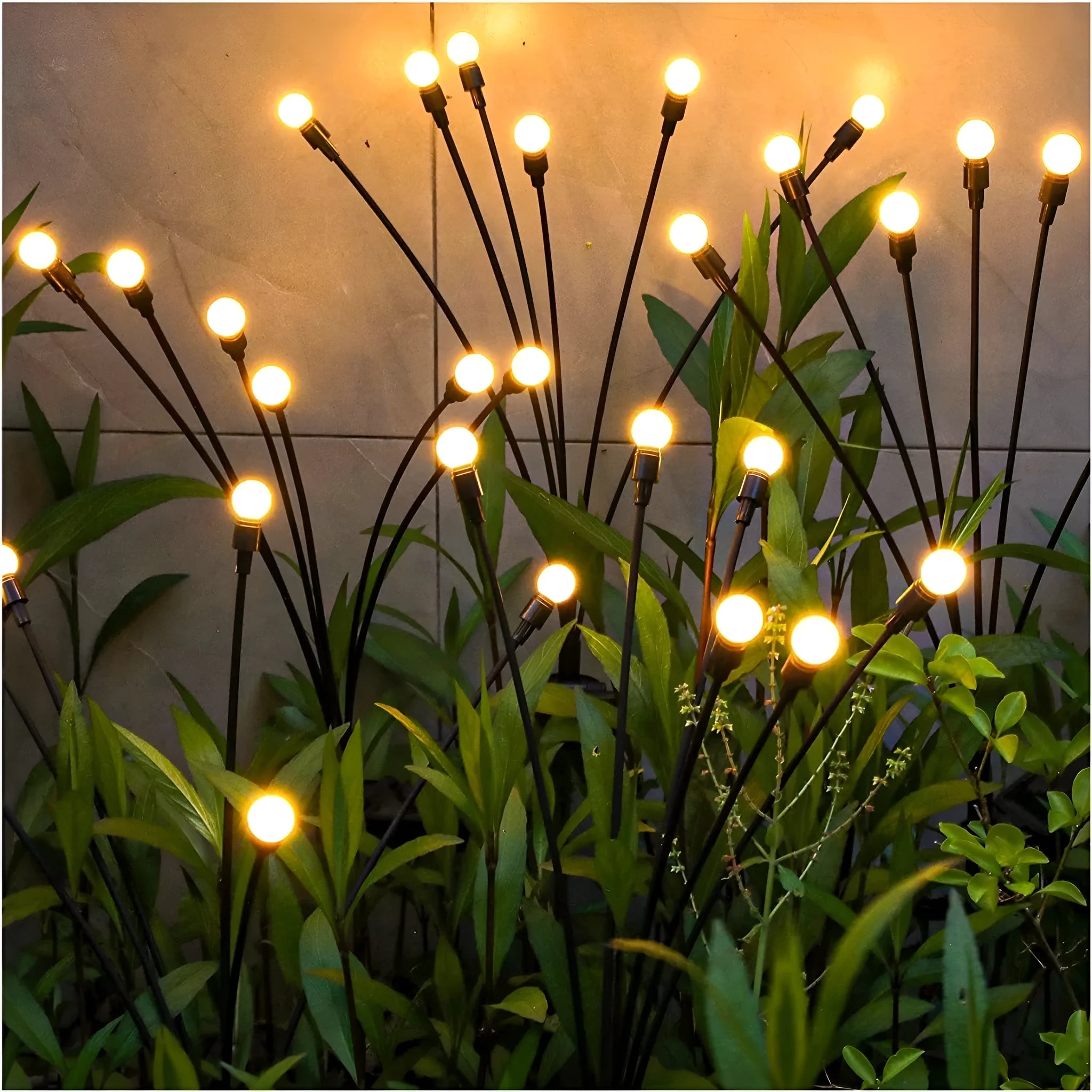Set of solar-powered LED garden spike lights with multiple heads on stainless steel stakes for lawn or pathway.