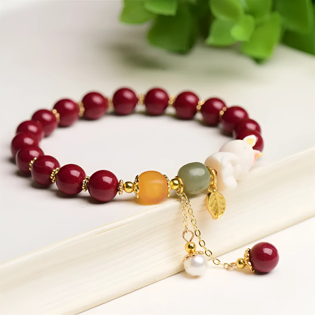 Women's bracelet with natural beeswax, purple gold sand beads, and a red cinnabar rabbit charm.