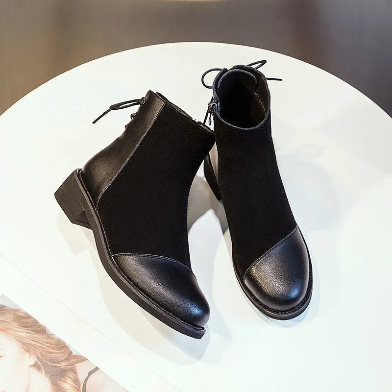 Black women's knee-high Martin boots with side zip, bow detail, and a round toe on a non-slip rubber sole.