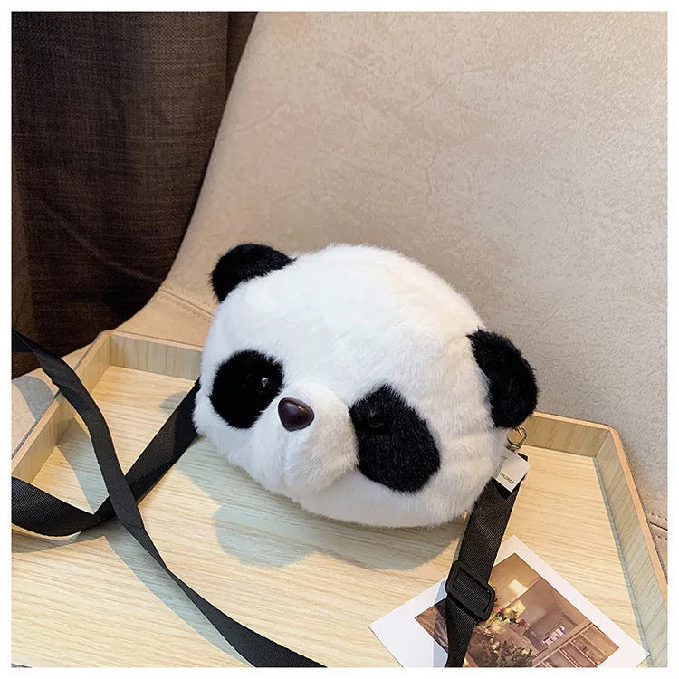 Soft plush crossbody bag with panda head design, cylindrical shape, and outer pocket.