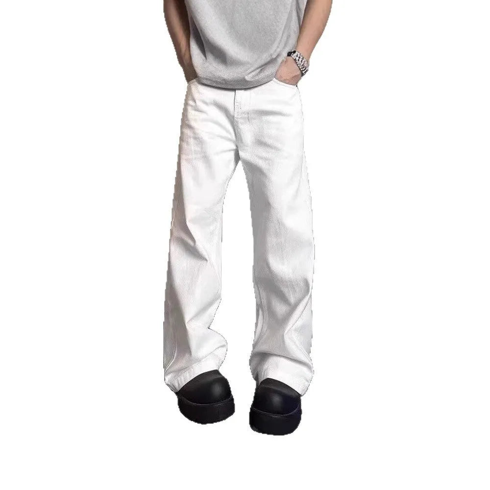Men's white loose fit straight-leg cotton denim jeans on a plain background.