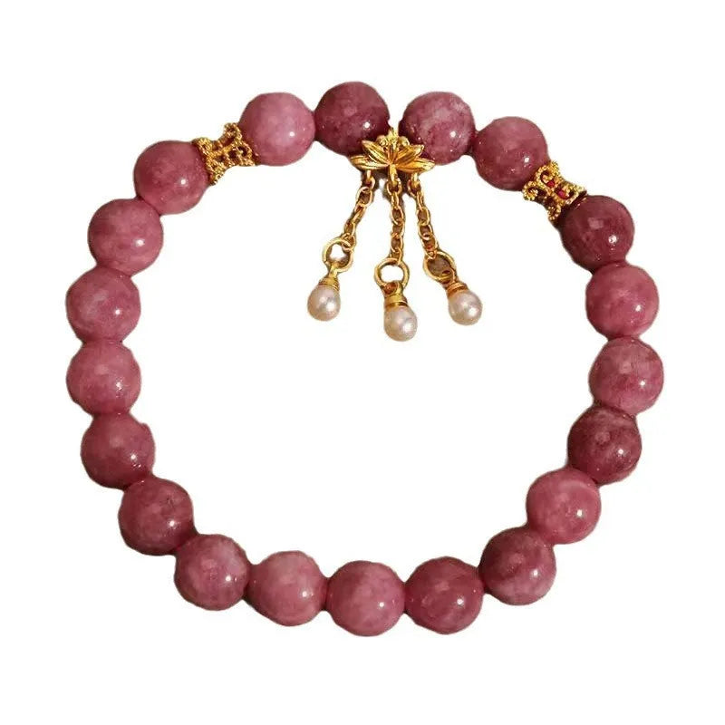 Natural stone beaded bracelet with pink lotus tassel, pearl pendant, and electroplated crystal beads on white background