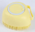 Blue silicone dog bath brush with flexible bristles on a white background