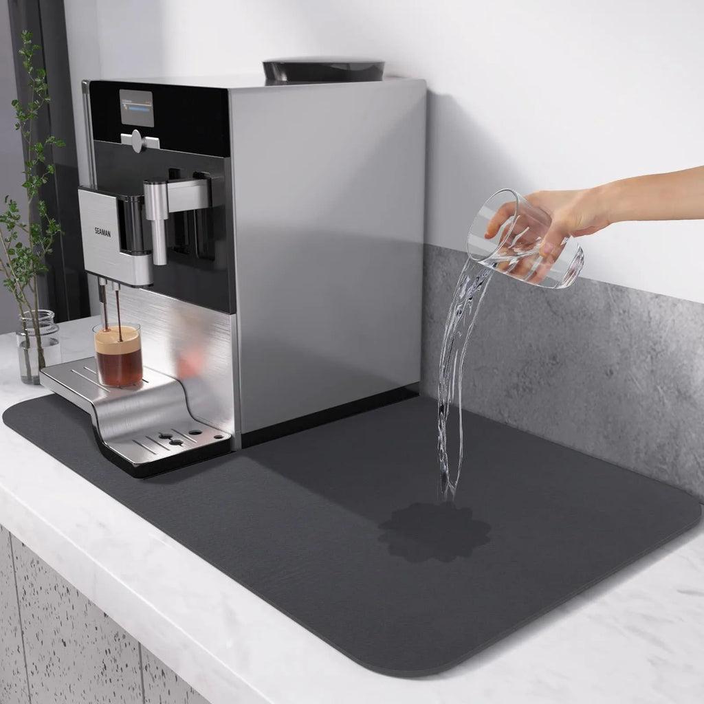 Super absorbent dish drying mat in black PU leather with non-slip rubber backing on a kitchen counter