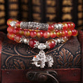 Handmade geometric bracelet made from natural watermelon crystal beads with a traditional Chinese knot clasp.