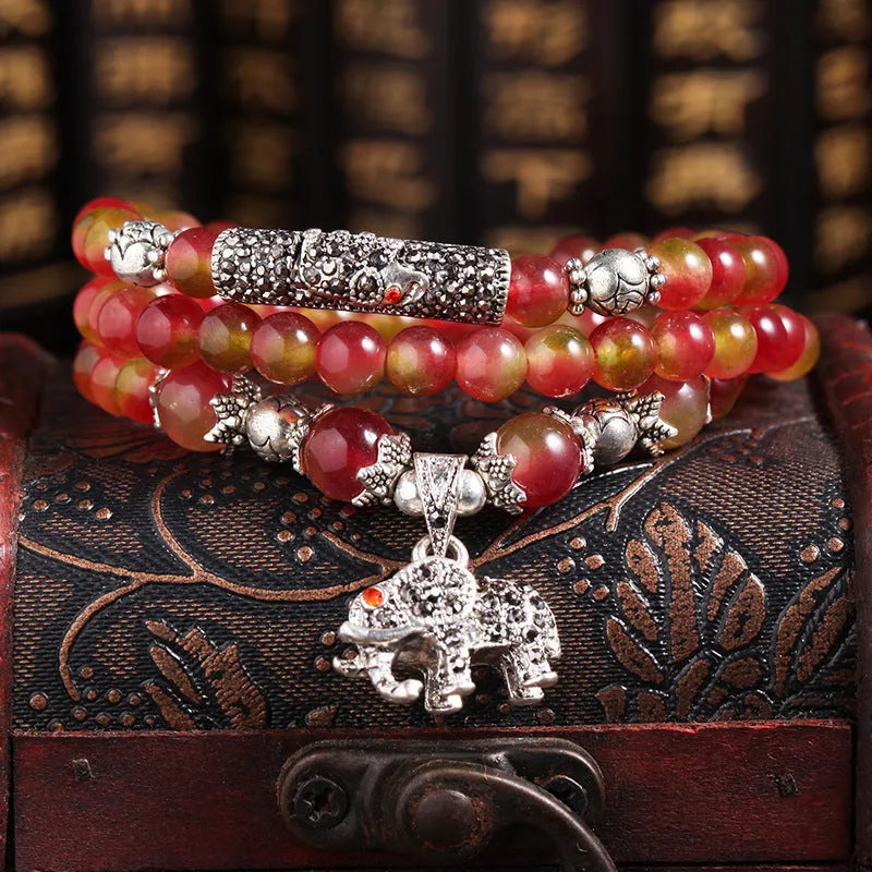 Handmade geometric bracelet made from natural watermelon crystal beads with a traditional Chinese knot clasp.