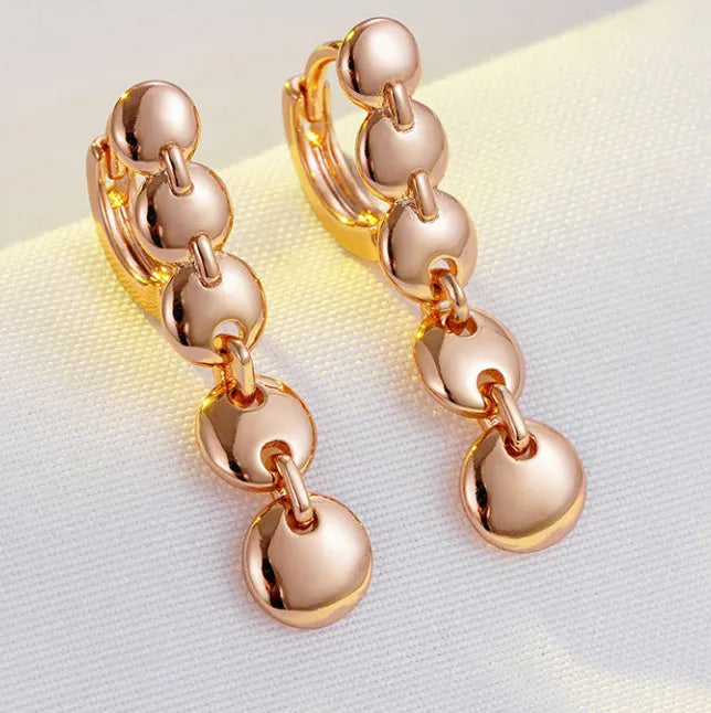 Gold retro long round circle drop earrings with woven wire construction.