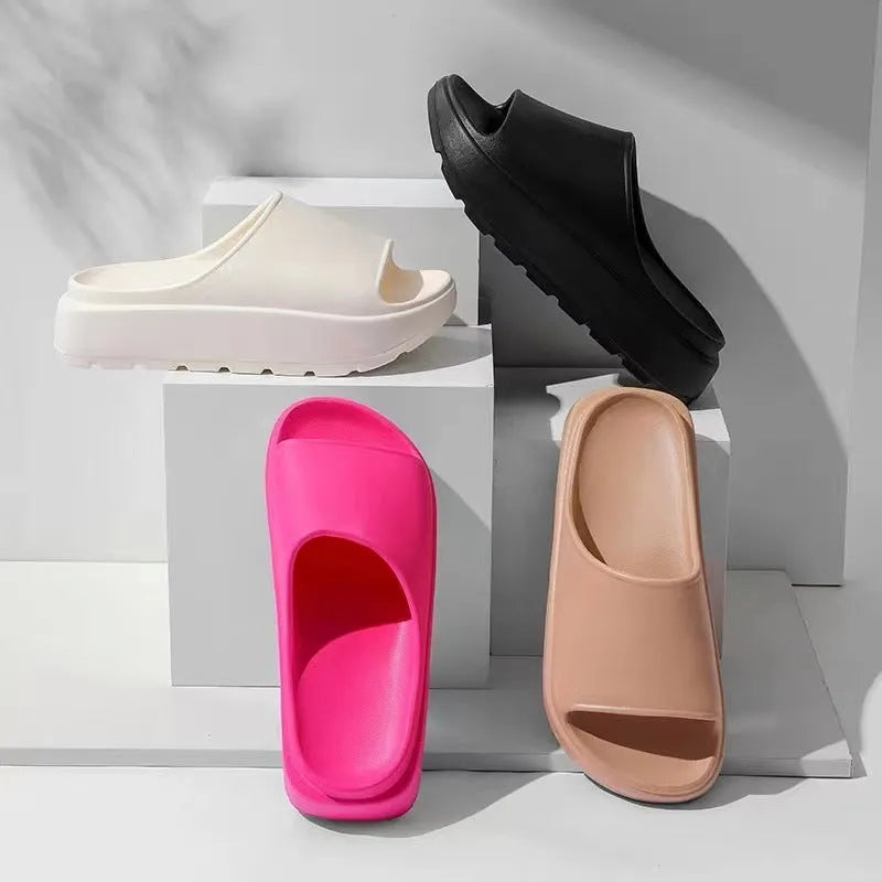 Women's beige fish mouth slippers with a thick 5.5cm light-coloured EVA sole on a wooden floor.