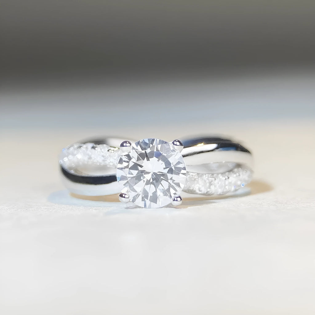 Silver moissanite ring with 1 karat stone and cross twisted arm geometric design